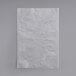 A white paper bag on a gray surface.