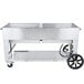 A large stainless steel Crown Verity outdoor rental grill with wheels.