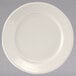 A close-up of a Tuxton Reno ivory china plate with a wide white rim.