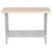 An Advance Tabco wood top work table with a stainless steel base and undershelf.