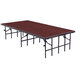 A National Public Seating single height portable stage set up on a rectangular table with a red top.