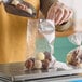 A person putting chocolates in a Choice clear polypropylene layflat bag.