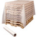 A pallet with a roll of white plastic on top wrapped in plastic.