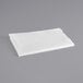 a folded white paper on a gray background