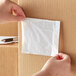 A person holding a Lavex clear plastic packing list envelope.