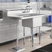 A Regency stainless steel commercial sink with a left drainboard on a counter.