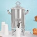A silver Choice Coffee Chafer Urn with a "Decaf" label on a silver tray with white cups and muffins.