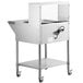 An Avantco stainless steel mobile electric steam table on wheels with a wire shelf and glass sneeze guard.
