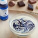 A bowl of liquid with blue and white swirls.