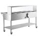 An Avantco stainless steel food warmer on wheels with a clear sneeze guard.