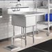 A Regency stainless steel one compartment sink with a right drainboard on a counter in a kitchen.