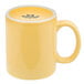 A yellow Tuxton china mug with a C-handle.