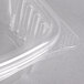 A close-up of a Genpak clear plastic deli container with a hinged lid.
