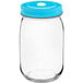 An Acopa clear glass drinking jar with a blue lid.