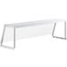 A white rectangular metal object with a clear plastic cover.