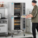 A double deck full size liquid propane digital convection oven with steam injection and casters.