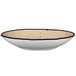 A white porcelain pasta bowl with a black rim.