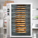 An Alto-Shaam hot pizza holding cabinet with pizzas inside.