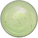 A lime green porcelain bowl with black specks.