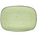 A lime green rectangular porcelain platter with black specks.