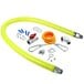 A yellow T&S Safe-T-Link gas hose with metal fittings and hoses.