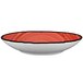 A close-up of a International Tableware Rotana pasta bowl with a red rim.