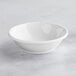 a white bowl on a marble surface