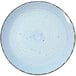 A close up of a blue and white speckled International Tableware Rotana Iceburg coupe porcelain plate.