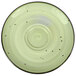 A white porcelain saucer with black dots on it.