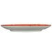 A white porcelain plate with a red rim and orange accents in a box.