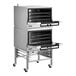 A double deck full size electric convection oven with mechanical controls and casters.
