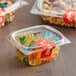 A clear plastic Choice deli container filled with gummy bears and nuts.