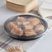 A plastic container of food on a table at a catering event.