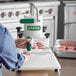 A woman using a Garde slider press to make hamburgers on a counter.