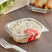 A clear plastic Choice deli container with food inside.