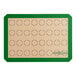 A green and white Baker's Lane baking mat with circles for 32 macarons.