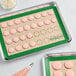 A Baker's Lane green silicone baking mat with cookies on a tray.