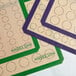 A Baker's Lane green silicone baking mat with circles for 2" macarons.