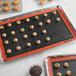 Baker's Lane Full Size Non-Stick Baking Mat with cookies on a tray.