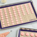 A Baker's Lane purple silicone baking mat with 64 pink circles.