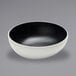 An American Metalcraft slanted melamine bowl with black specks on a white surface.