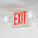 A Lavex red and green LED exit sign and emergency light combo mounted on a ceiling.