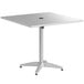 A white square Lancaster Table & Seating outdoor table with a metal base and umbrella hole.