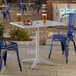 A rectangular silver powder-coated aluminum outdoor dining table with an umbrella hole.
