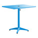 A blue powder-coated aluminum outdoor dining table with a square top, central pedestal base, and an umbrella hole.
