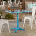 A blue powder-coated aluminum outdoor dining table with an umbrella hole, measuring 24 by 32 inches.