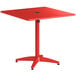 A red square Lancaster Table & Seating outdoor table with a metal base.