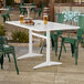 A rectangular white powder-coated aluminum outdoor dining table with an umbrella hole.