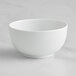 A Bauscher bright white porcelain teacup on a white surface.