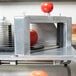 A Vollrath straight blade assembly for a Redco InstaSlice tomato slicer on a counter.